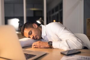 Work fatigue, business man and sleeping office employee feeling burnout from night deadline. Sleep